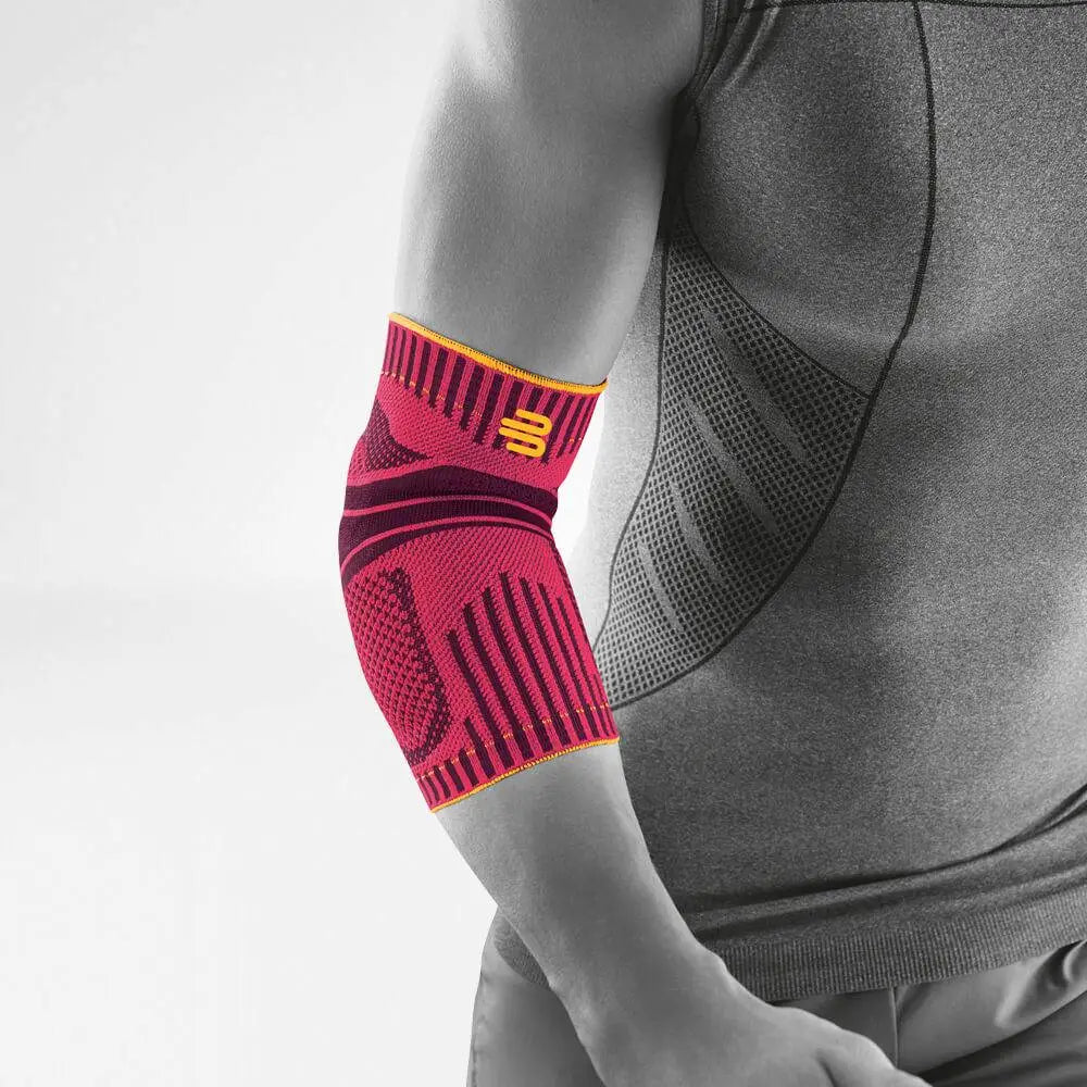 Die Abbildung zeigt den Bauerfeind Sports Elbow Support, eine sportliche Ellenbogenbandage, die zur Unterstützung und Stabilisierung des Ellenbogengelenks während körperlicher Aktivität entwickelt wurde. Die Bandage besteht aus atmungsaktivem, komprimierendem Material, das sich eng an den Ellenbogen anschmiegt und die Muskulatur aktiviert. Sie ist mit anatomisch geformten Pelotten ausgestattet, die gezielten Druck ausüben, um Schmerzen zu lindern und die Gelenkführung zu verbessern.