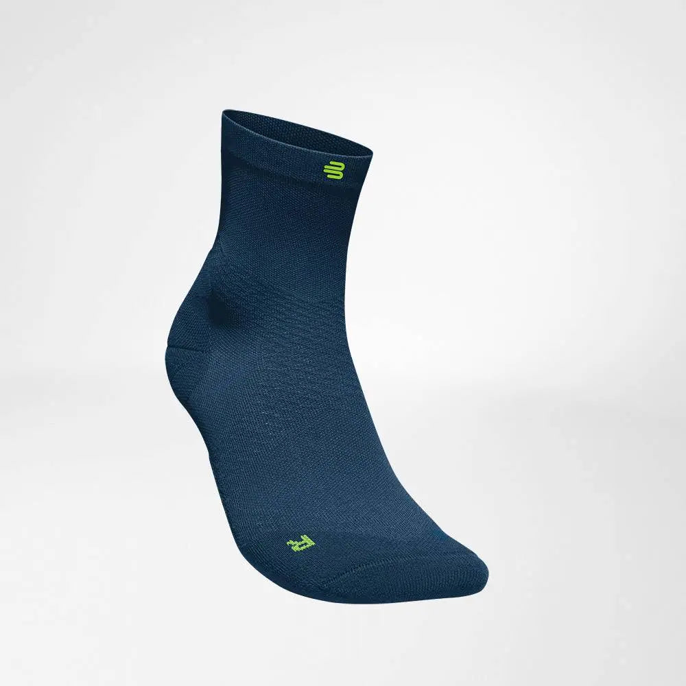 Die Abbildung zeigt die Bauerfeind Run Ultralight Mid Cut Socken, die speziell für Läufer entwickelt wurden. Diese Socken bestehen aus ultraleichtem, atmungsaktivem Material, das Feuchtigkeit effektiv ableitet und für ein angenehmes Tragegefühl sorgt. Die Mid Cut Länge bietet eine optimale Passform und leichten Schutz im Knöchelbereich. Zusätzlich unterstützen sie die Fußmuskulatur durch gezielte Kompression und fördern die Durchblutung, was Ermüdung und Blasenbildung vorbeugt.