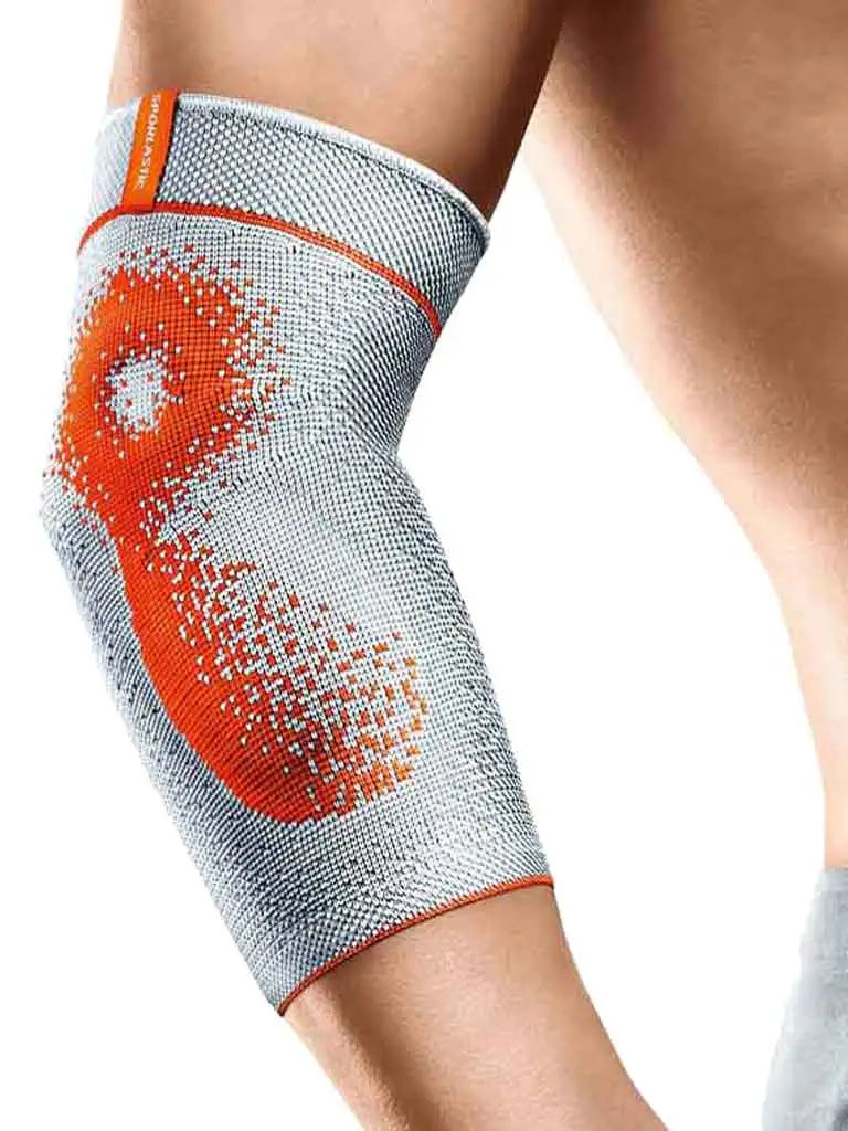 Die Abbildung zeigt die Sporlastic Epidyn Supreme Bandage, eine hochwertige Bandage zur umfassenden Unterstützung des Ellenbogengelenks. Sie besteht aus elastischem, atmungsaktivem Material und bietet gezielte Stabilisierung durch integrierte Silikonpelotten, die sanften Druck auf den Ellenbogen ausüben, um Schmerzen zu lindern und Schwellungen zu reduzieren.